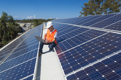 Solar Technician Checking Panel Production